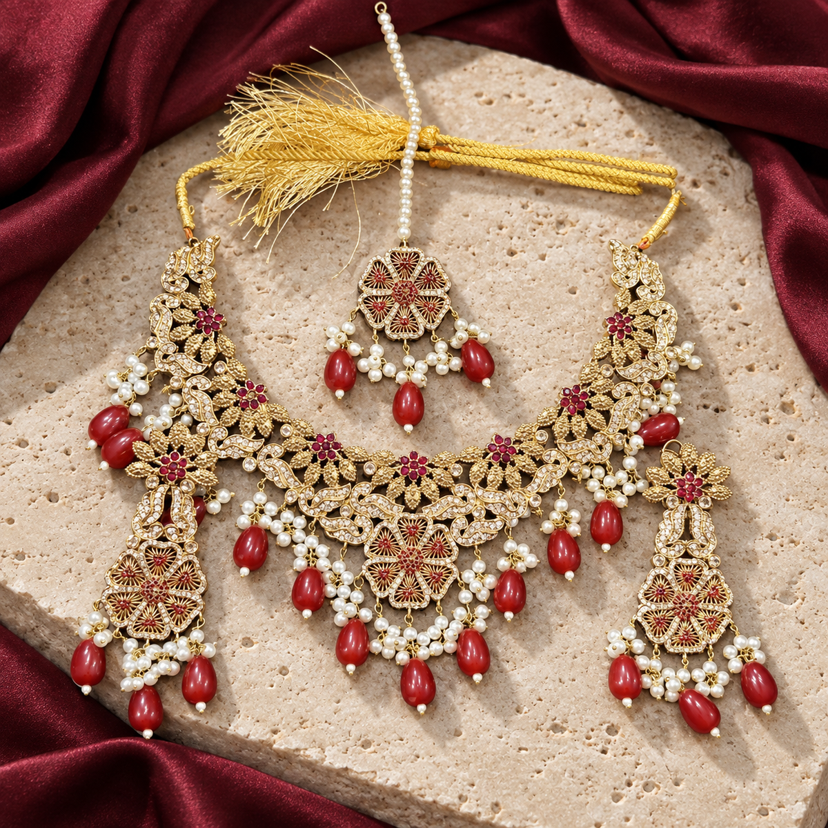 Jewellery styled on ivory travertine with burgundy silk