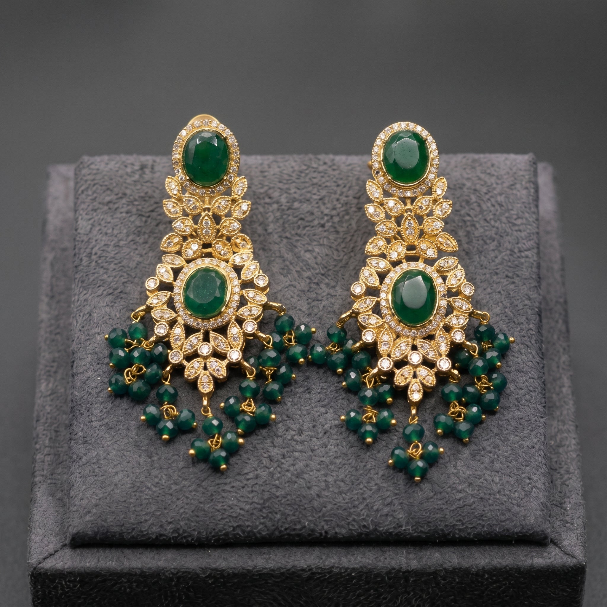 Emerald Green Oval Stone Earrings close-up detail — artificial earrings by Jashan Jewels
